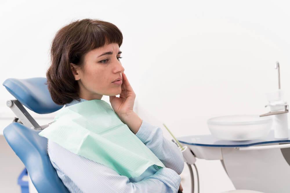 woman with toothache at the dental office