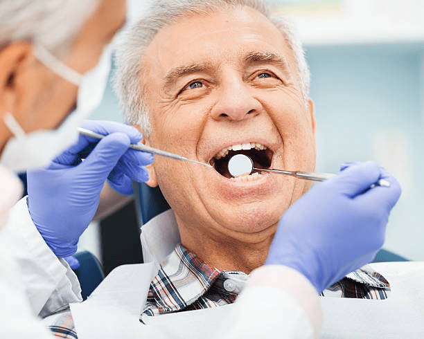 an elderly man having his dental check-up
