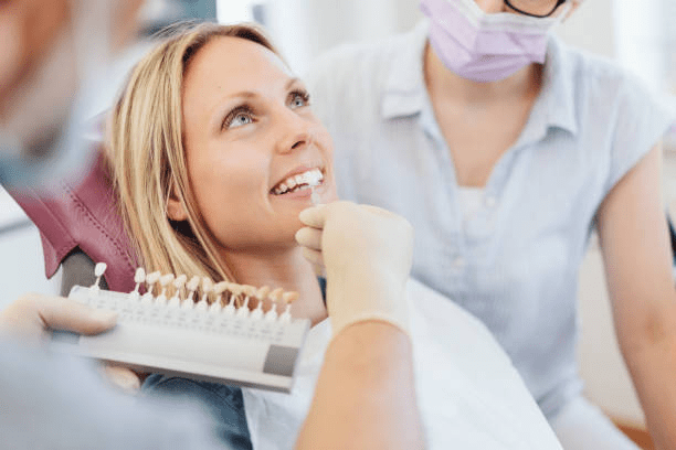 a woman choosing the shade of her veneers